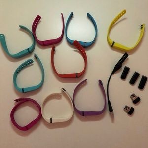 Three Fitbits with Bands and Charger